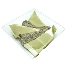 a white plate topped with gold colored napkins