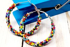 Cute Cute Cutedid I mention how cute these beauties are! Perfect go to earrings....these bold, rainbow hoops literally go with everything. Great for a casual day at the office or fun night on the town.  Lightweight and comfortable for any occasion! These 1.5" (in) hoop earrings, perfect for those going for a modern boho look. They make great gifts for your loved ones. NOTE: These are all one of a kind designs so no two pair are identical!  Arrives in a decorative gift box See more hoop earrings: https://www.etsy.com/shop/ChristalDreamz?section_id=16666926&ref=shopsection_leftnav_2 Thanks for stopping by to see my DreamZ! Have a Wonderful Day! Cute Birthday Gift, Cute Birthday, Rainbow Beads, Earrings Cute, Colorful Rainbow, Beaded Hoop Earrings, Beaded Hoops, Birthday Gift For Her, Seed Bead Earrings