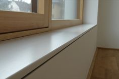 an empty window sill in front of a white wall