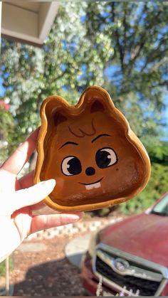 someone holding up a cookie shaped like a bear