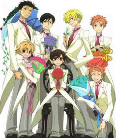 the seven main characters are dressed up in suits and ties, with flowers on their lapels