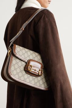 Gucci only revived its '1955' style a few seasons ago, but it's already set to be the next It bag - both Sienna Miller and Adwoa Aboah have been spotted carrying it. Made in Italy from the house's signature monogrammed coated-canvas, it has a saddle silhouette and is trimmed with tan leather. Match your jewelry to the equestrian-inspired horsebit hardware. Vintage Gucci Coated Canvas Shoulder Bag, Classic Gucci Bag In Signature Coated Canvas, Vintage Gucci Monogram Canvas Shoulder Bag, Vintage Leather Bags With Horsebit Detail, Vintage Rectangular Shoulder Bag With Horsebit Detail, Vintage Business Bags In Signature Coated Canvas, Classic Gucci Monogram Canvas Shoulder Bag, Vintage Gucci Office Bag, Vintage Gucci Shoulder Bag With Horsebit Detail