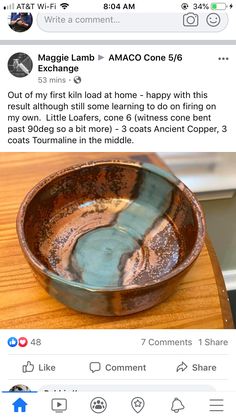 a brown bowl sitting on top of a wooden table