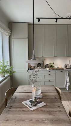 a wooden table sitting in front of a window