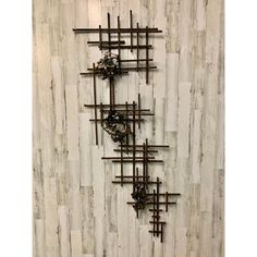 a metal sculpture on the side of a wooden wall