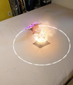 a bed with a white circle on top of it and a purple object in the middle