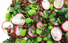 a salad with radishes, green beans and other veggies on it