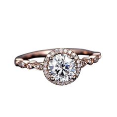 a rose gold engagement ring with an oval diamond center and twisted shans on the band