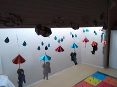 several people with umbrellas hanging from the ceiling