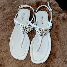 Prada - White Patent Leather Logo Thong Sandal Brand New, Open Dox Color: White Size: 35 ( It Is Fit Those People Who Wear Us 5, 5.5 Or 6 With Skinny Feet) Got It From Nordstrom Designer Toe Post Sandals For Beach, Luxury T-strap Beach Sandals, Office Sandals, Prada Sandals, Ballerina Heels, Black Heels Low, Shoes Prada, Leather Thong Sandals, Cork Wedges Sandals