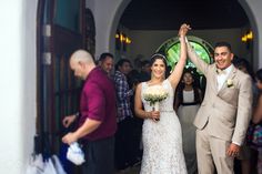 a bride and groom walking down the aisle at their wedding