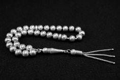 925 Sterling Silver Rosary 925 Ayar Gümüş Tespih Prayerbeads Silver Rosary Tesbih Tespih Tasbih Silver rosary with 33 beads Weight of rosary: 20.7 Gram PRICE INCLUDES SHIPPING We try to take photos that look as real as possible. However, it cannot be ruled out that color deviations may occur due to light or settings. This is not a reason for complaint. We can send you a product video before your purchase if you wish. Silver Hand-strung Rosary As Gift, Handmade Silver Traditional Rosary, Handmade Traditional Silver Rosary, Traditional Silver Rosary With Polished Beads, Traditional Handmade Silver Rosary, Traditional Silver Rosary As Gift, Handmade Silver Rosary With Round Beads, Silver Rosary, Product Video