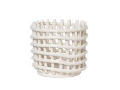 a white basket that is sitting on the ground