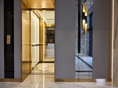 the entrance to an office building with marble floors and walls