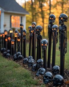 halloween decorations are lined up in front of a house