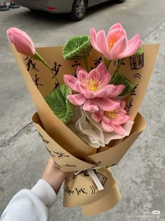 a person holding a bunch of flowers in their hand