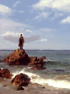 a man standing on top of a rock in the ocean with an angel wings above his head