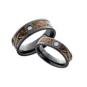 two wedding rings with camo inlays and white diamond accents, set on top of each other