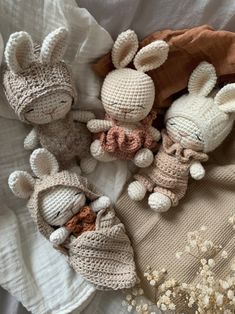 three crocheted stuffed animals laying on top of a bed next to each other