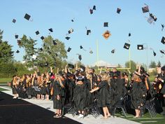 graduates throwing their caps in the air at graduation