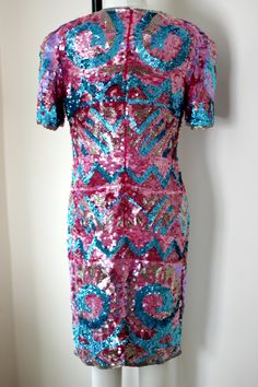 "So fun and so funky!! Vintage 80 sequin/bead hot pink, blue, silver dress! Sooo shiny and sparkly. You will definitely be the center of attention in this unique piece! 100% silk Zips in the back and is in Very good condition! I do not see any sequin loss. Hot pink silk lining Stunning geometric design with beautiful details Measuring: 38\" long Bust: 34\" Waist: 30\" Hip 36\" Pet free/ smoke free Enjoy!" Purple Sequin Dress For Summer, Pink Sequin Dress For Festive Occasions, Festive Pink Contrast Sequin Dress, Pink Disco Sequin Dress, Pink Sequined Disco Dress, Summer Festive Sequin Dress With Contrast Sequin, Pink Sequin Dress With Glitter For Holidays, Festive Summer Sequin Dress With Contrast Sequin, Pink Sequin Fabric For Evening Party Season