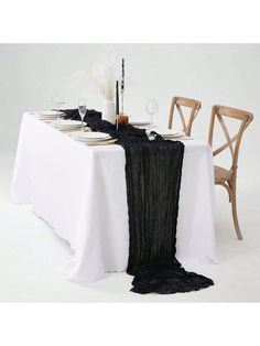 the table is set with black and white linens