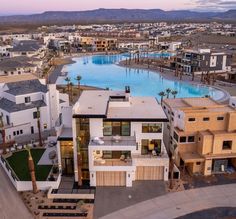 this is an aerial view of a house in the desert with swimming pool and palm trees