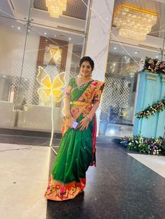 a woman in a green and orange sari