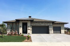 a large house with two garages in front of it