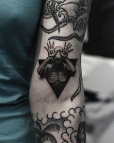 a person with a black and white tattoo on their arm