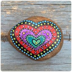 a painted rock with a heart on it