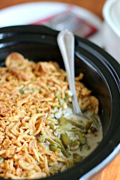 a crock pot filled with green beans and onion casserole