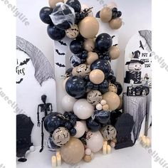 a bunch of balloons that are in the shape of a tree with bats on it