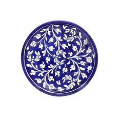 a blue and white plate with flowers on the rim, isolated against a white background