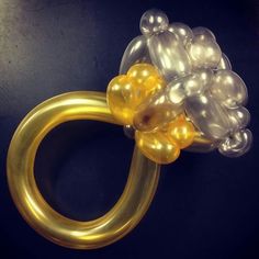 a gold ring with balloons attached to it