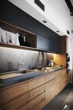 a kitchen with wooden cabinets and stainless steel counter tops, along with black appliances in the background