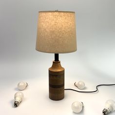 a lamp that is sitting on the ground next to some light bulb plugged in