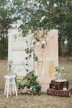 an old door is surrounded by greenery and other items