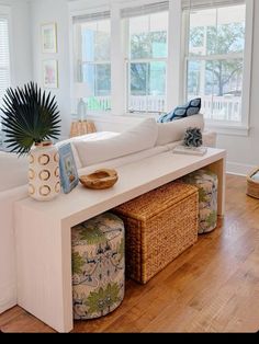 a living room filled with furniture and lots of windows