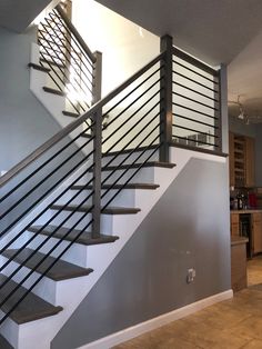 a stair case with metal handrails in a kitchen