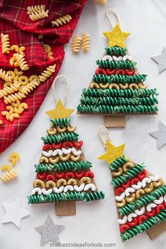 three christmas tree ornaments made out of pasta