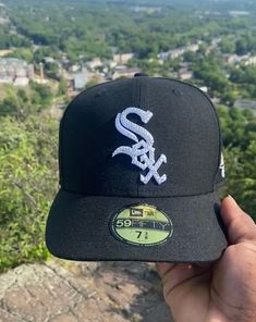 the chicago white sox hat is on top of a mountain