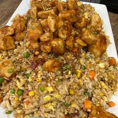 a white plate topped with rice and chicken