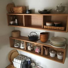 the shelves in the kitchen are filled with dishes