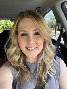 a woman sitting in the back seat of a car