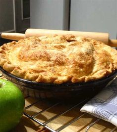 an apple pie sitting on top of a cooling rack