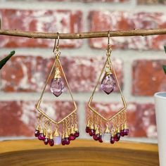 Introducing these boho chic chandelier earrings, which combine an array of magical gemstones and combination of colors.  These earrings are created using hand-forged 14k gold filled earring frames. Each earring is adorned individually wire wrapped Rhodolite Garnets and Ethiopian Opals that sway from the bottom of the gold frames. Large stunning AAA pink Amethyst hang front in center making them the main focal of these earrings.  Click here to see our full line of handmade gemstone earrings: http Magical Gemstones, Amethyst Chandelier, Chic Chandelier, Earring Frame, Gold Frames, Gemstone Jewelry Handmade, Gold Filled Earrings, Rhodolite Garnet, Pink Amethyst