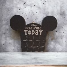 a mickey mouse head with the words celebrate today written on it