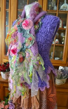 a mannequin is covered in many different colored fabrics