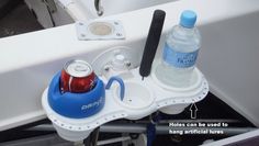 two water bottles are sitting on the edge of a boat's sink and holder